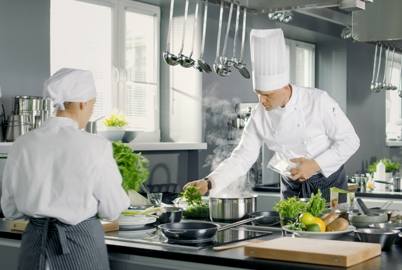 Chef prepping meal in kitchen of restaurant