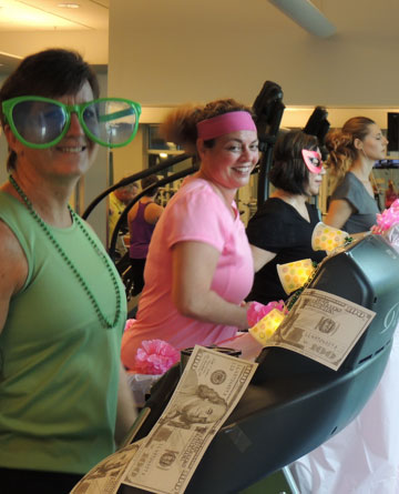 Teammates in costumes walking on treadmills